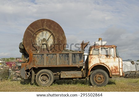 Old dump truck being used to hold and store gill fishing net on a large real on the Oregon coast.