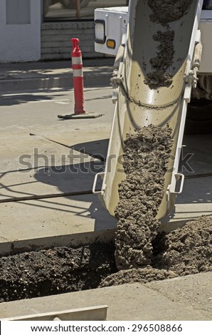 Using a special contract slurry to backfill a sanitary sewer pipe installation during a road re-construction project