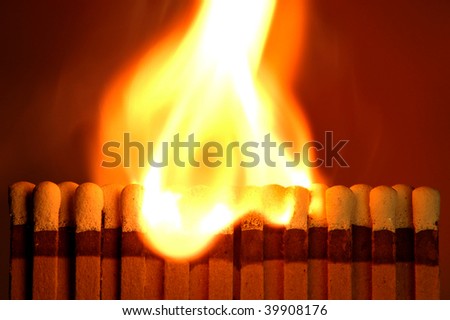 Flame traveling horizontally on a newly opened matchbook as taken for a playing with matches fire department display