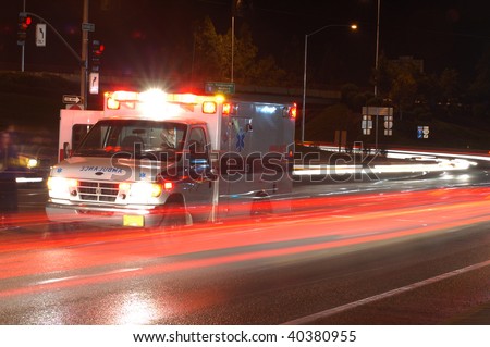 Ambulance standing in night traffic at a motor vehicle accident in early winter, Roseburg Oregon