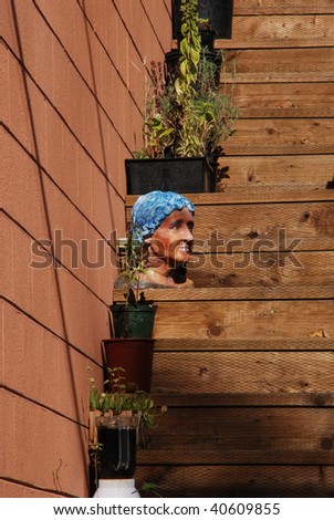 Plants and a Head Sculpture on the back stairs of a home in the Downtown area of Grants Pass OR