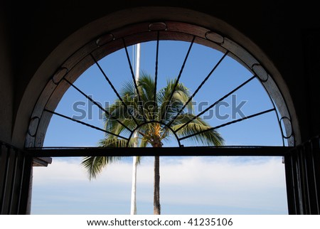 Palm Tree and Arch Window from a restaurant on the Malecon in old town Puerto Vallarta, Mexico,