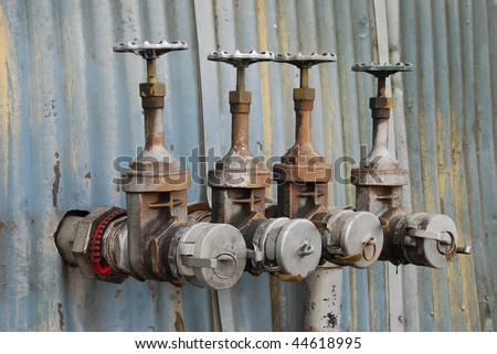 Old fuel transfer valves on a building in the industrial area of Portland Oregon