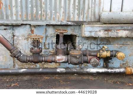 Old fuel transfer valves on a building in the industrial area of Portland Oregon