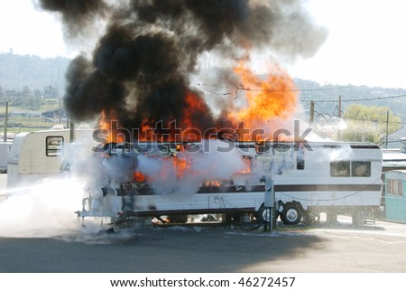stock photo Well involved fire in a travel trailer being used as a 