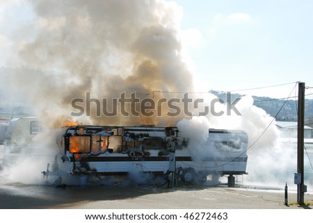 stock photo Well involved fire in a travel trailer being used as a