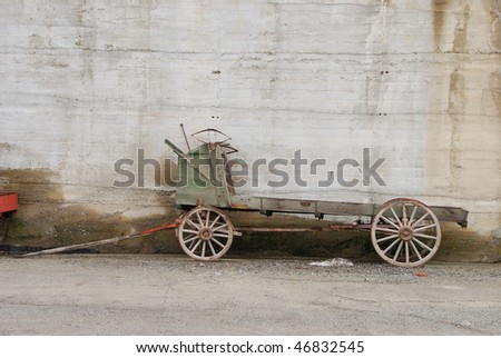 Old orchard delivery wagon against a cold storage warehouse wall in the Wenatchee Washington area.