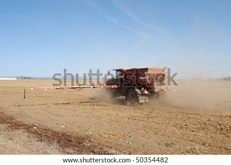 Fertilizer Spreader working an field in Klamath Falls area.  Rig is from Basin Chemical and Fertilizer Company