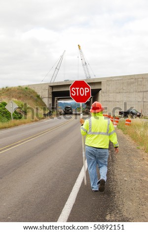 Flagger controlling the traffic during The rebuilding of the Shady Bridge of Interstate 5 crossing the South Umpqua River just south of Roseburg Oregon
