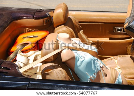 Mannequin riding in a convertible.