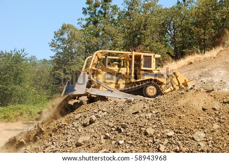 Large Bulldozer working a rock hill on a new business  project in Roseburg Oregon