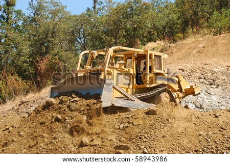 Large Bulldozer working a rock hill on a new business  project in Roseburg Oregon