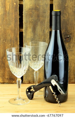 Empty wine glasses and a yet to be opened bottle of wine.