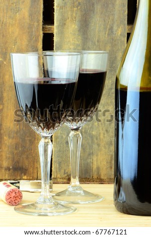 Filled wine glasses with a fresh bottle of wine