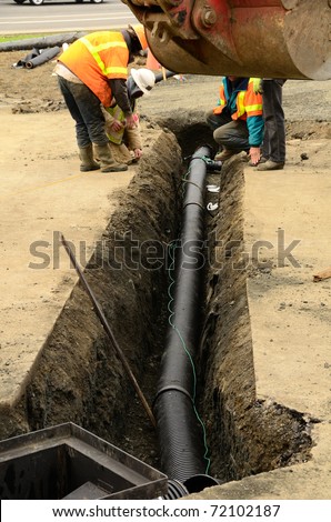 Putting in a drain pipe to a parking lot catch bin in a new commercial development in Roseburg Oregon