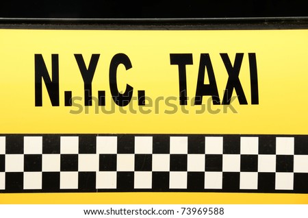 NYC Taxi sign on yellow.