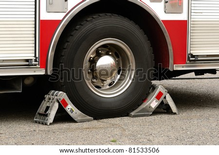 Wheel chocks on a fire engine back tires.