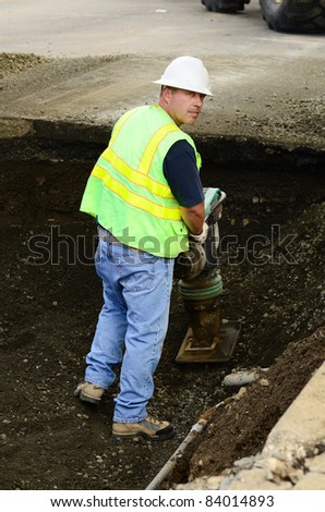 Compacting the backfill in the excavation hole to repair a 12 inch water main failure on Harvard Ave in Roseburg OR