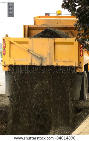 Dump truck filling gravel into the excavation hole to repair a 12 inch water main failure on Harvard Ave in Roseburg OR