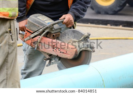 Cutting new plastic pipe to repair a 12 inch water main failure on Harvard Ave in Roseburg OR