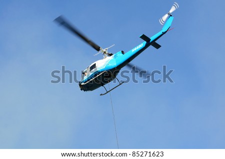 MYRTLE CREEK, OREGON - SEPTEMBER 18: Large helicopter with a 500 gallon water bucket (not pictured) works a natural cover fire near Myrtle Creek, OR, USA on September 18, 2011