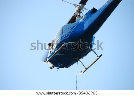 MYRTLE CREEK, OREGON - SEPTEMBER 18: Large helicopter with a 500 gallon water bucket (not pictured) works a natural cover fire near Myrtle Creek, OR, USA on September 18, 2011
