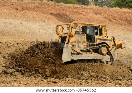 A large bulldozer working the grade for a new road and freeway interchange near Roseburg Oregon