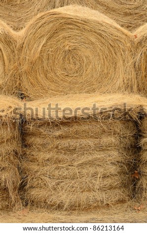 Stack of round bales of grass hay used for winter cattle feed.