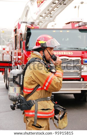 ROSEBURG, OREGON - FEB 11 - An unidentified fire lieutenant communicates with fire command on a commercial structure fire drill, on February 11, 2012 in Roseburg, Oregon
