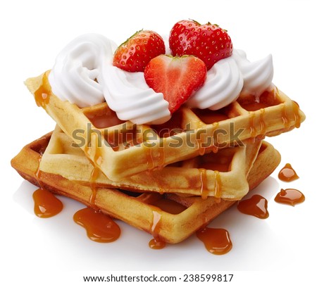 Belgian waffles with whipped cream, strawberries and caramel sauce  isolated on white background