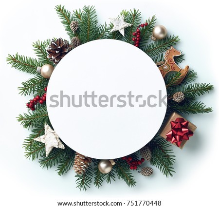 Round frame of Christmas tree branches and decorations with blank card and space for text. Top view. Xmas and New year concept