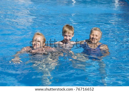 grandmother and grandson swimming in the pool