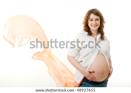 Pregnant woman with a brown scarf flying on wind