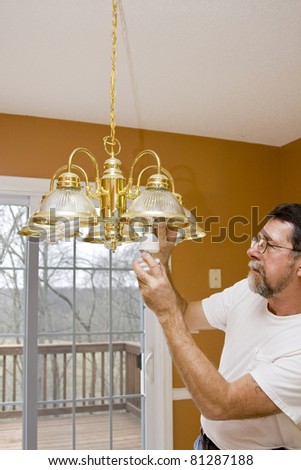 Home owner install energy saving light bulbs in dining room,bathrooms & kitchen to save energy & money
