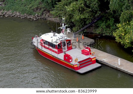 Looking down on fire department boat parked at dock, waiting for emergency calls