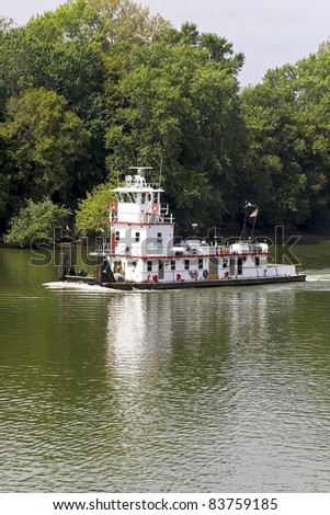 Tug boat going down river to meet a tourist boat