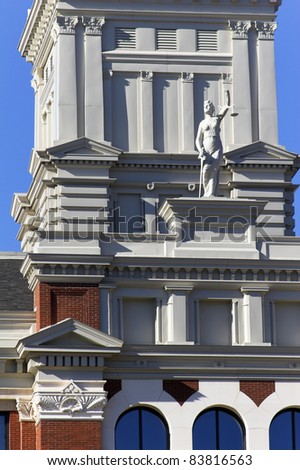Closeup of Court house with statute of lady justice holding scales