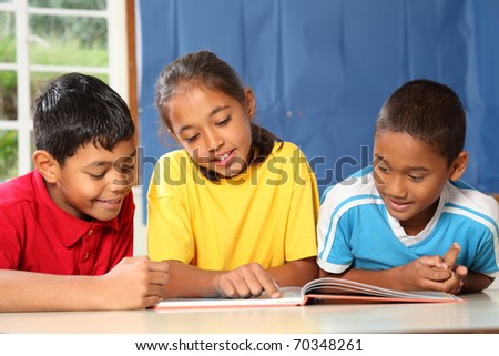 Primary school kids learning together in classroom