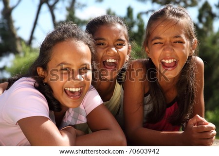 Three school girls enjoying happy moment in the sunshine
