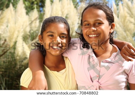 stock photo Two happy young school girls share a friendship hug in 