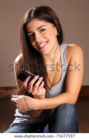 Beautiful happy woman enjoying smart phone music