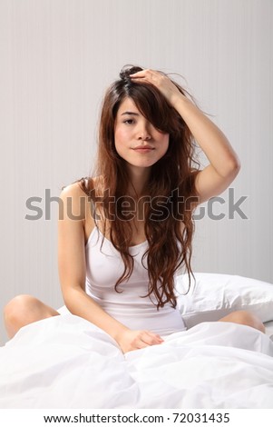 Beautiful woman sitting up in bed bad hair