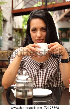 Beautiful girl enjoying quiet cup of coffee