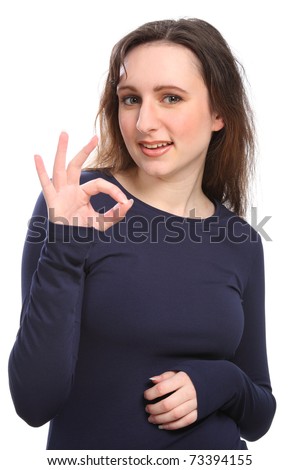 Beautiful happy young girl gives positive okay hand sign, wearing a navy blue long sleeve t-shirt.