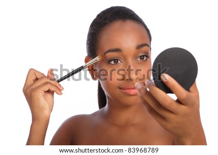 Applying  Makeup on Young African American Woman Applying Make Up Using Eye Shadow