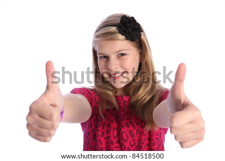 Two thumbs up hand sign for success by pretty caucasian school girl wearing pink t-shirt with black flower hair band in her blonde hair.