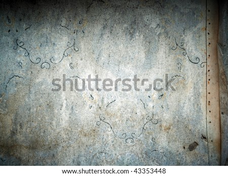 Old abandoned weathered wallpaper on outdoor wall.