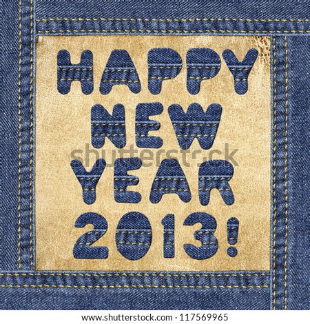 Holiday greeting - Happy New Year 2013! - made of denim letters in jeans frame on a leather label