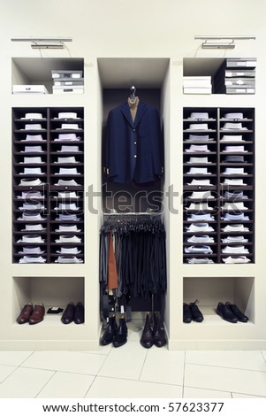 Stylish clothes in a modern shop interior - stock photo