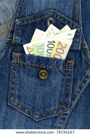 Easy money concept - closeup of many banknotes in blue jeans pocket